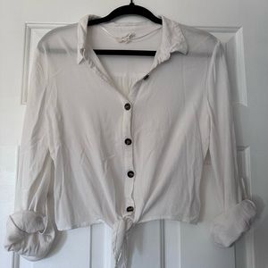 Off white nylon crop top with tie in front and option to roll up sleeves.